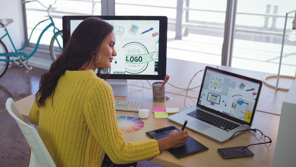 female graphic designer working in front of computers